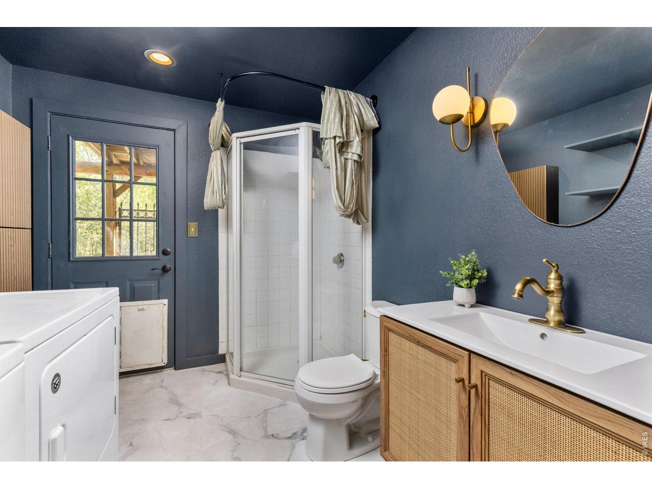665 Lower Travis Gulch Road Black Hawk, CO 80422 - Photo 22 of 47 Main level laundry + an updated 3/4 guest bath. Access to deck and yard