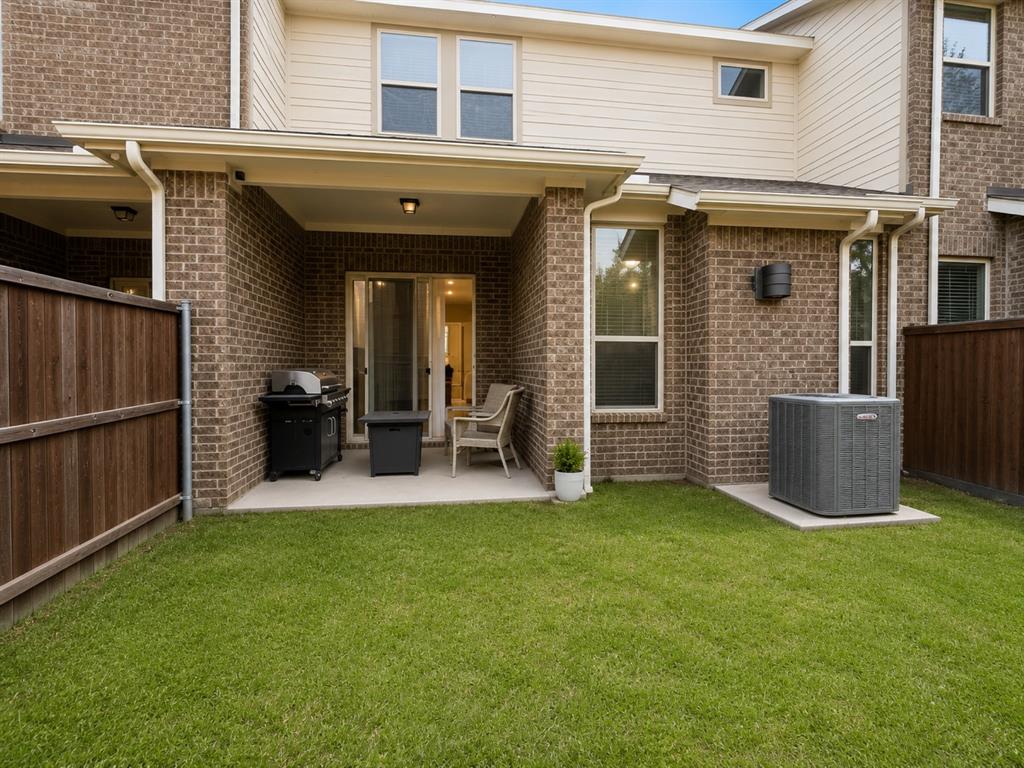 8235 Snapdragon Way Dallas, TX 75252 - Photo 24 of 29 Private fenced yard with a covered patio featuring a concrete slab and overhead lighting
