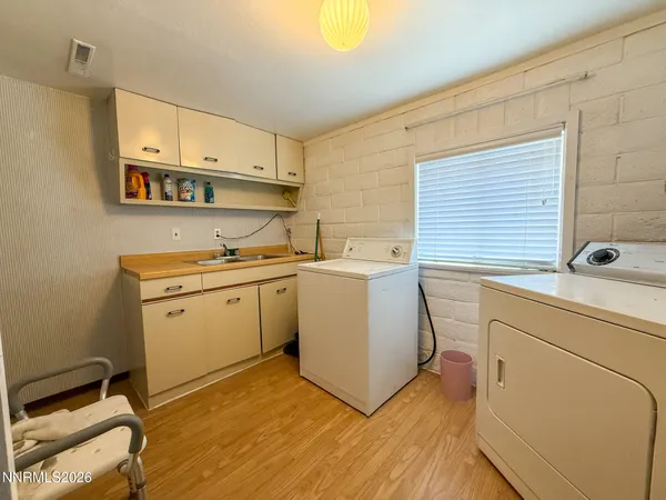 a utility room with cabinets washer and dryer