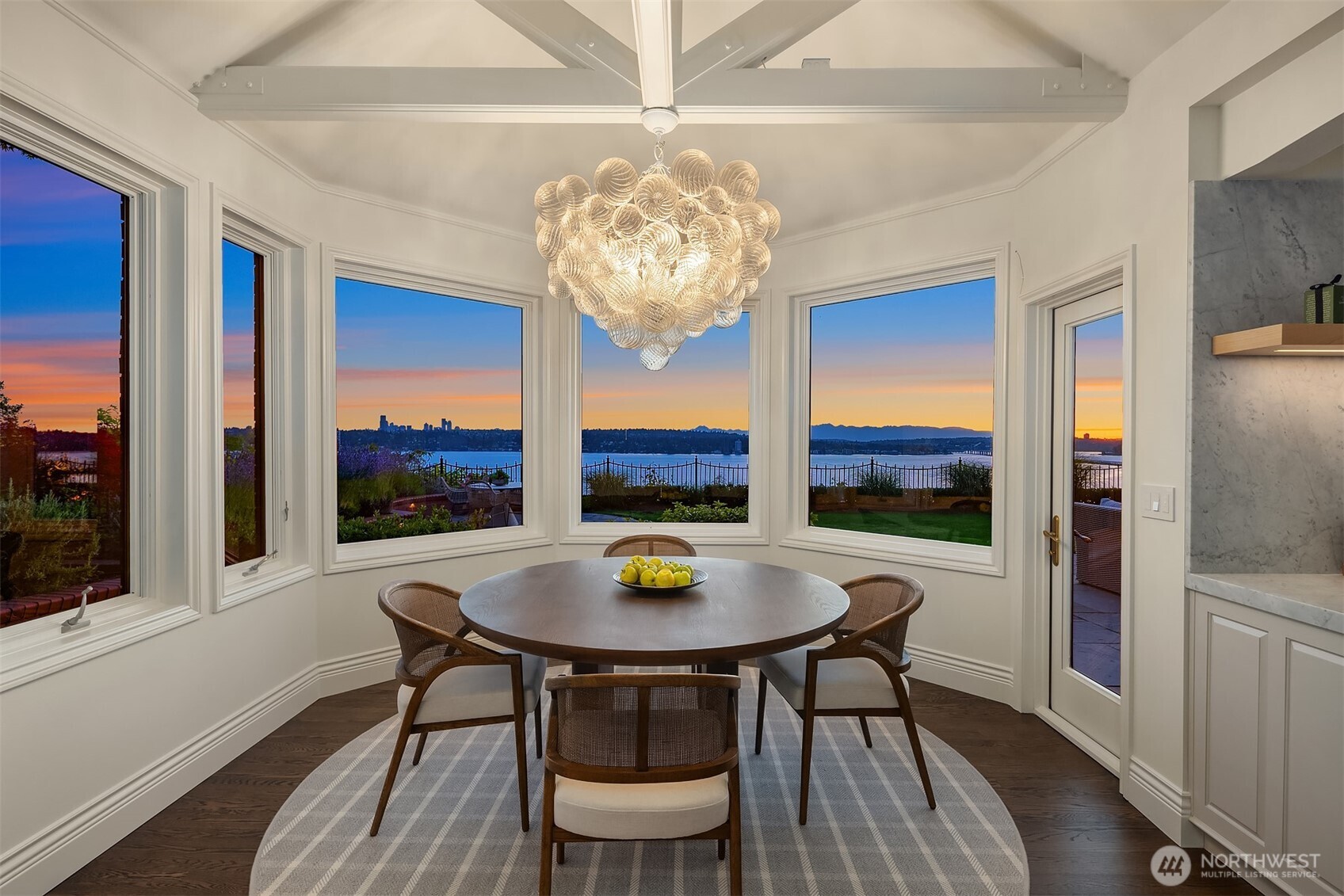 2307 Evergreen Point Road Medina, WA 98039 - Photo 14 of 40 a view of a dining room with furniture a chandelier and wooden floor