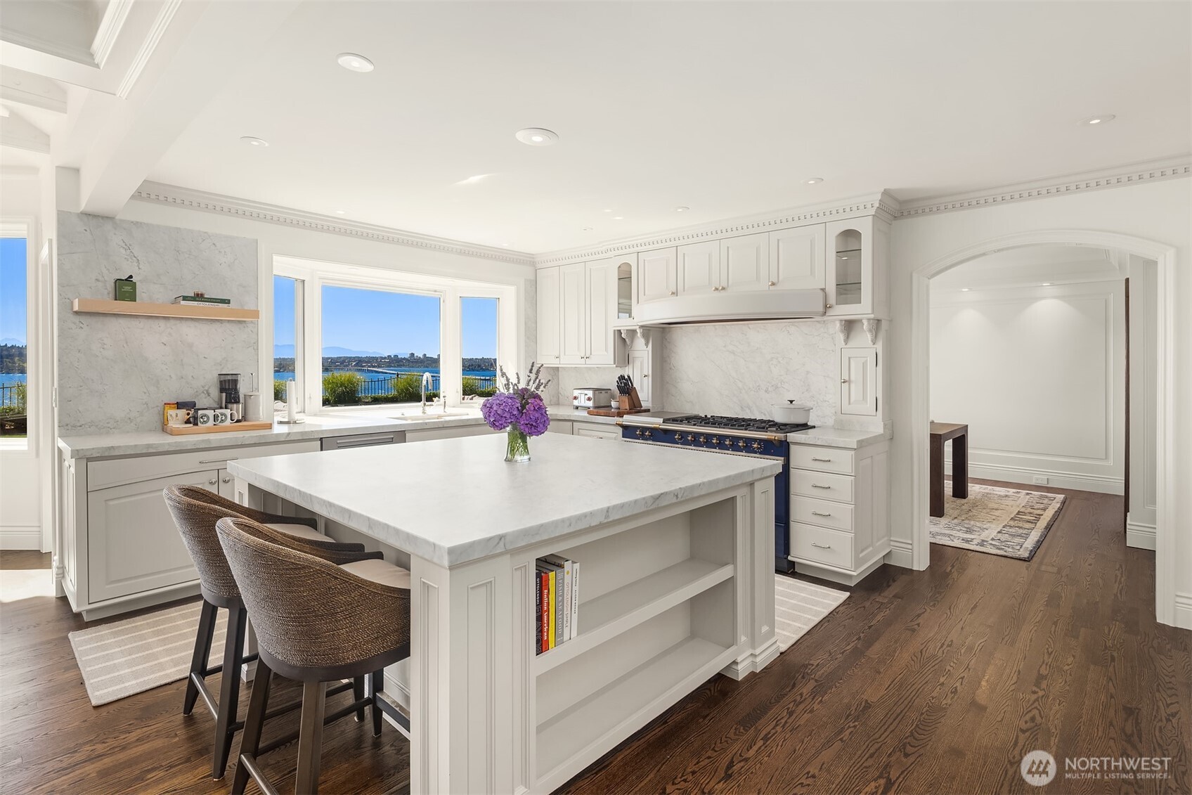 2307 Evergreen Point Road Medina, WA 98039 - Photo 17 of 40 a kitchen with granite countertop a stove a sink a refrigerator and a dining table with wooden floor