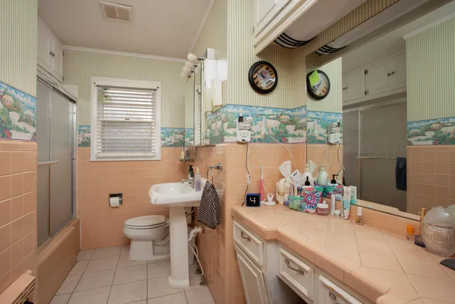 a bathroom with a toilet sink and mirror