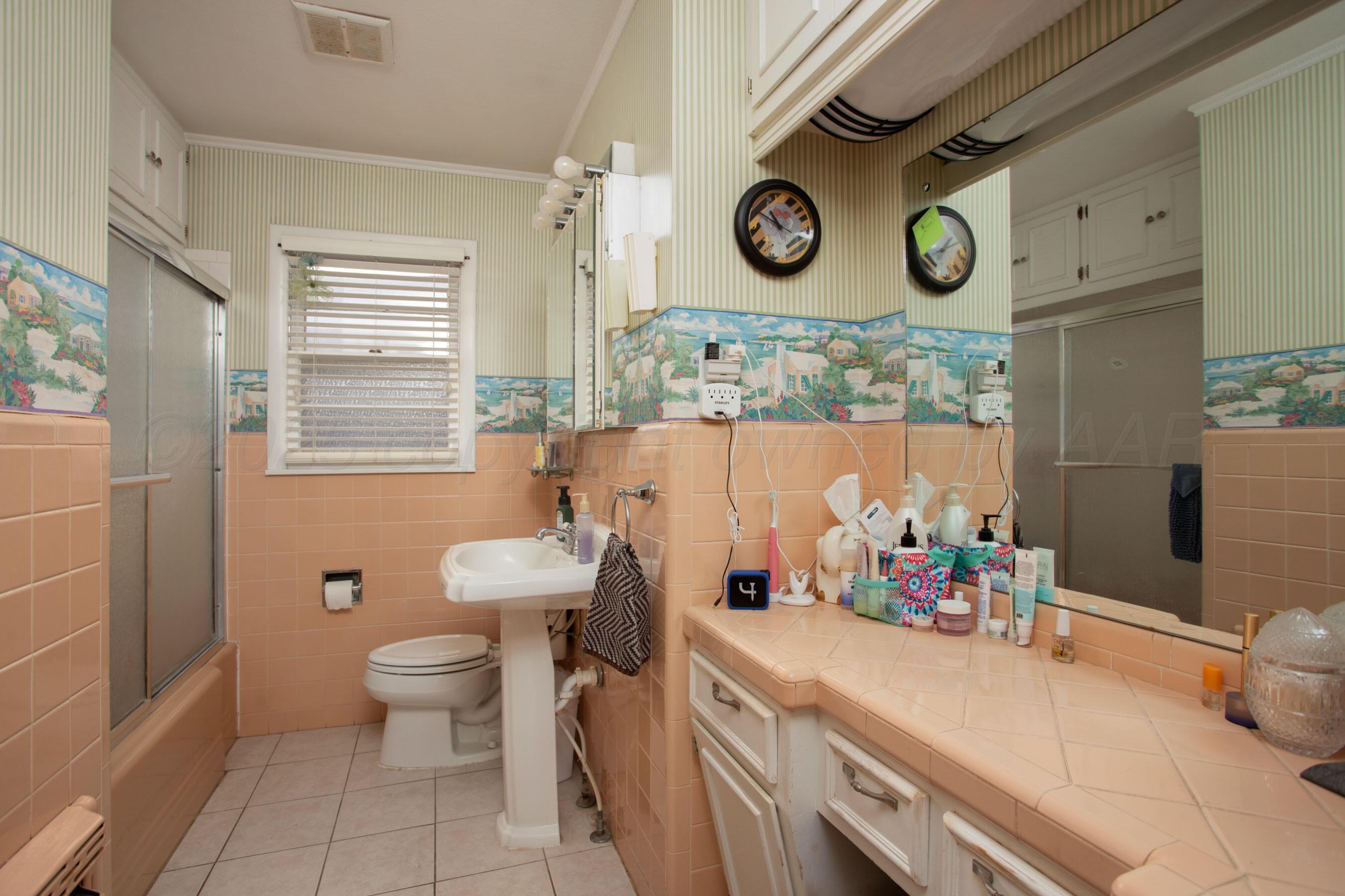 3600 Patterson Drive Amarillo, TX 79109 - Photo 21 of 31 a bathroom with a toilet sink and mirror