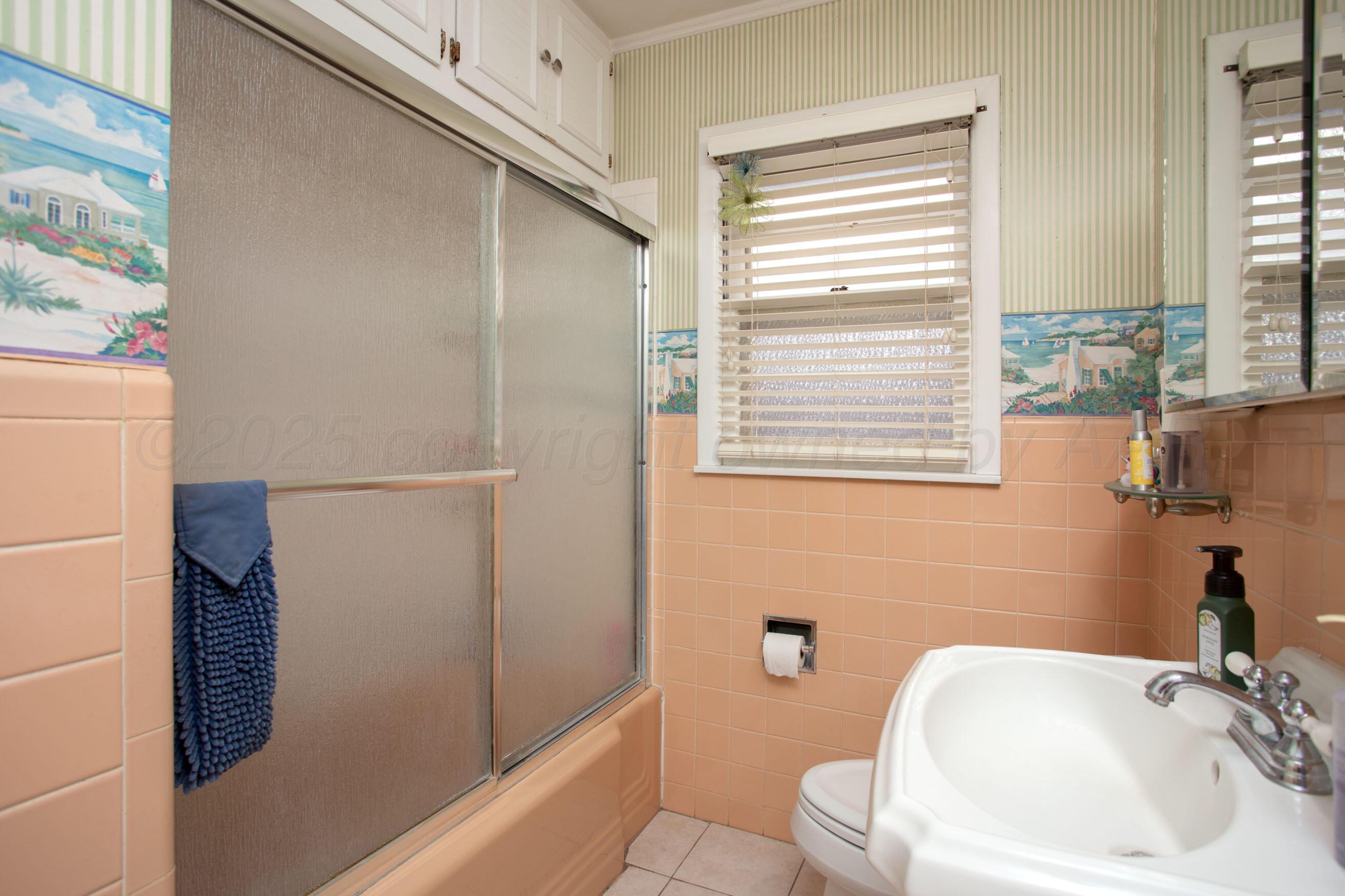 3600 Patterson Drive Amarillo, TX 79109 - Photo 22 of 31 a bathroom with a sink a toilet and shower