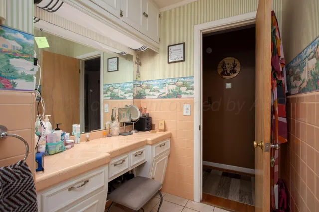 a bathroom with a sink a mirror and a shower