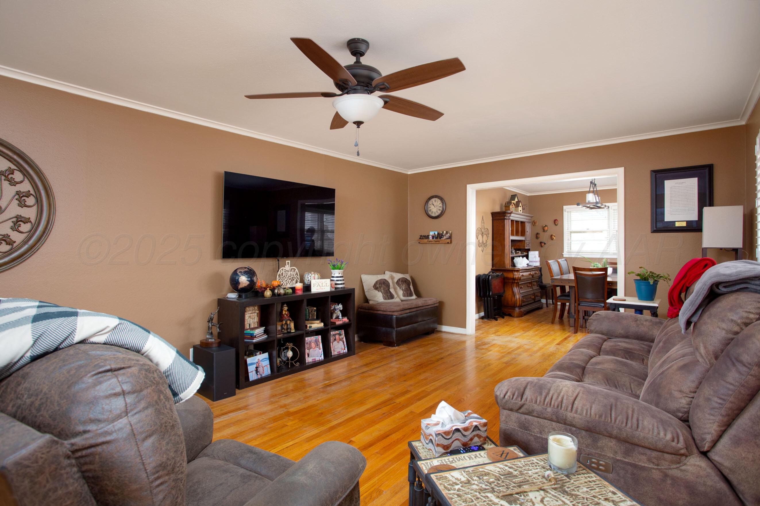 3600 Patterson Drive Amarillo, TX 79109 - Photo 7 of 31 a living room with furniture and a flat screen tv with wooden floor