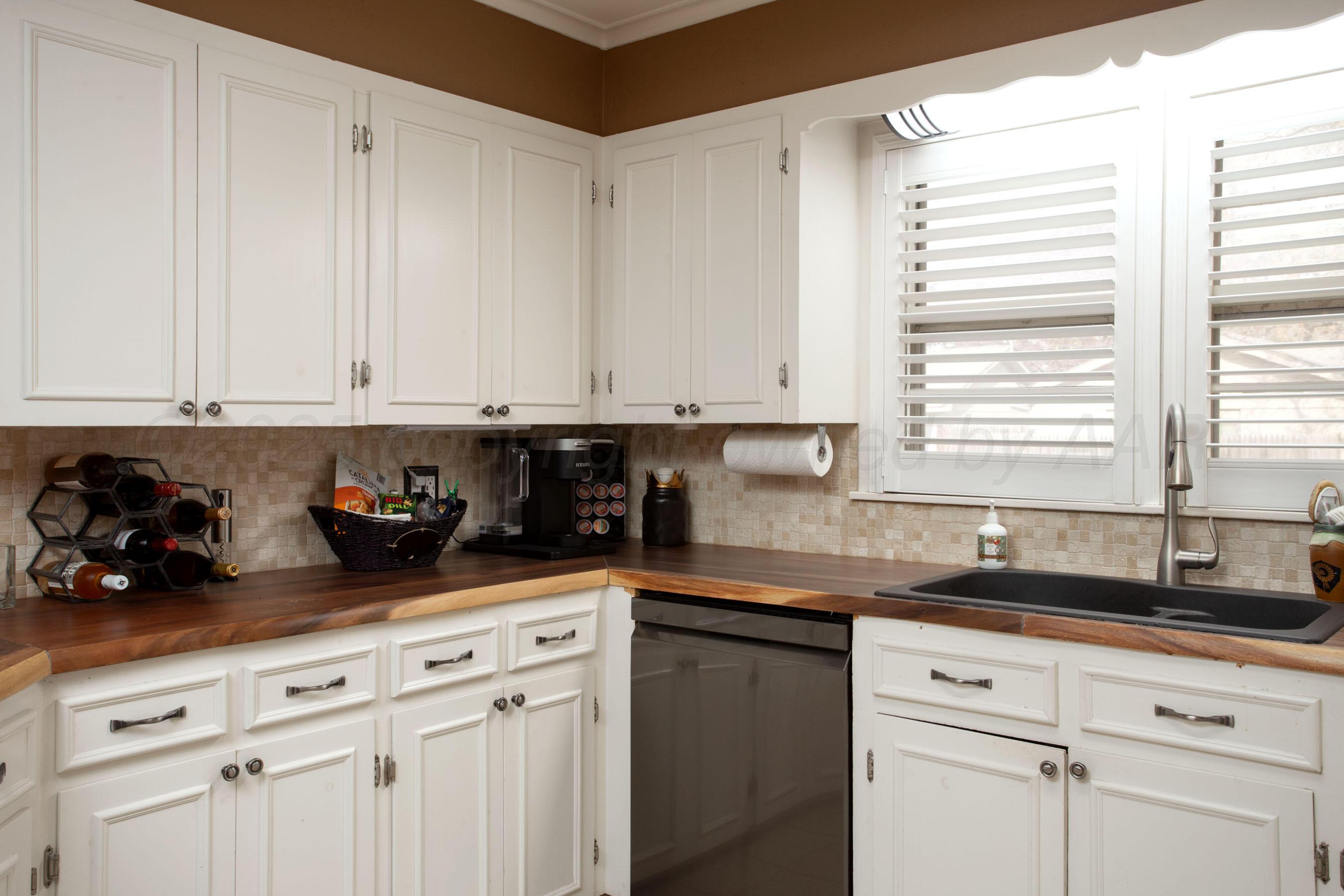 3600 Patterson Drive Amarillo, TX 79109 - Photo 10 of 31 a kitchen with granite countertop white cabinets and sink