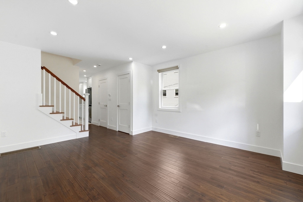 123 Nottinghill Road, Unit 2 Boston, MA 02135 - Photo 9 of 30 a view of an empty room with wooden floor and a window