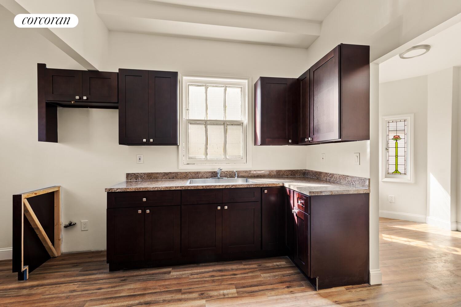 86 Lincoln Road Brooklyn, NY 11225 - Photo 6 of 12 a kitchen with a sink and a microwave