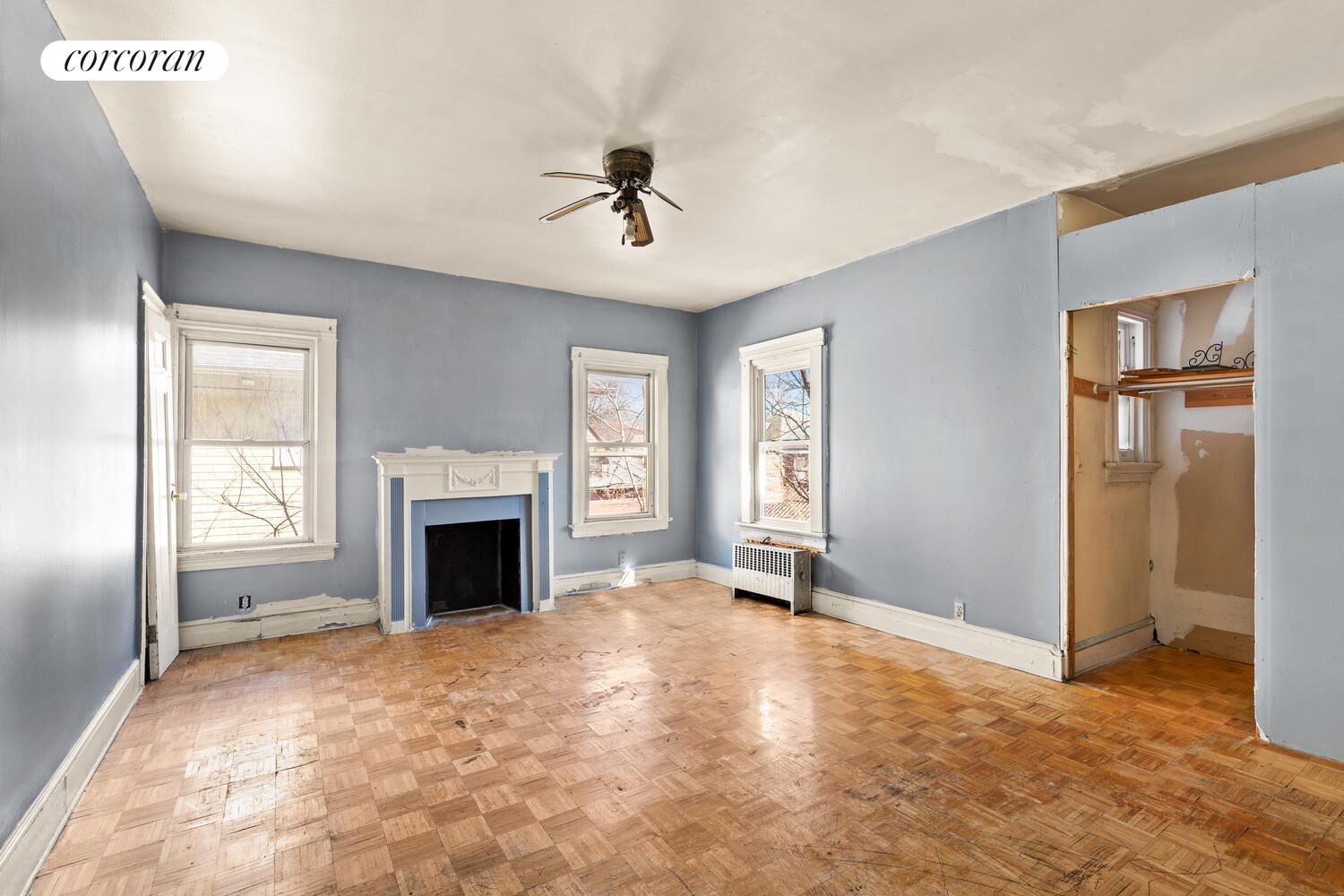 86 Lincoln Road Brooklyn, NY 11225 - Photo 8 of 12 a view of an empty room with window and fireplace