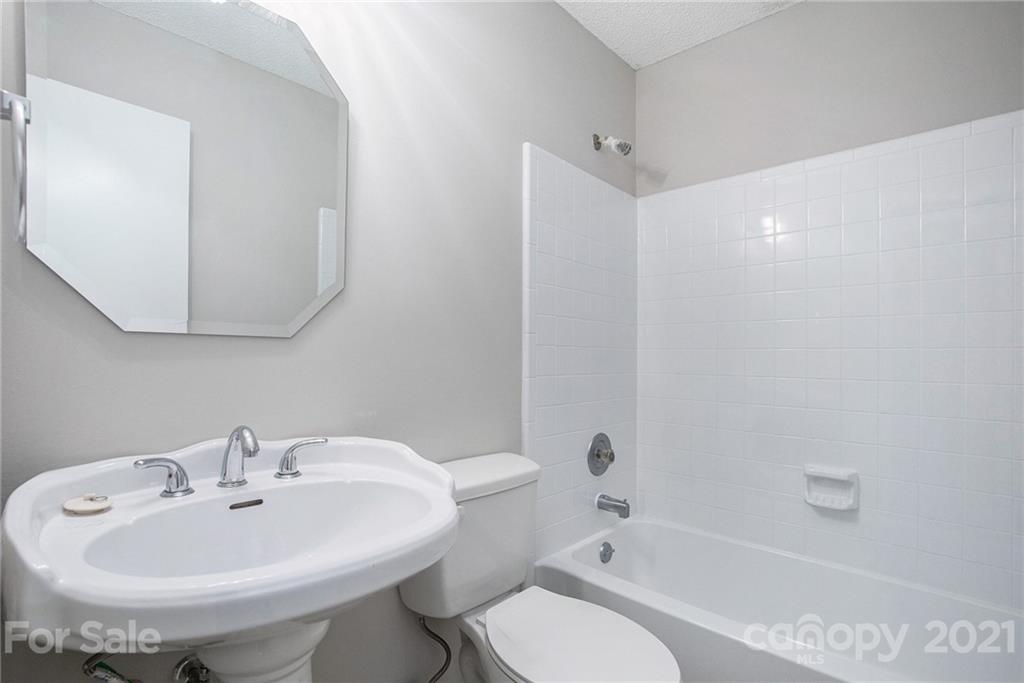 5625 Beaconsfield Road Charlotte, NC 28214 - Photo 17 of 21 a bathroom with a sink a toilet and shower