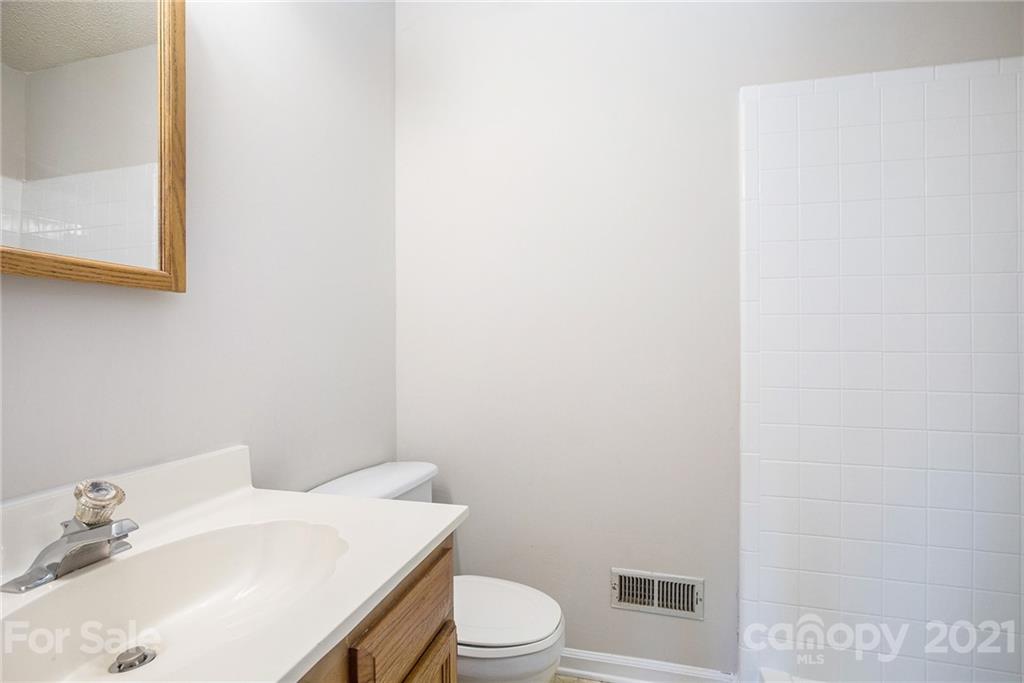 5625 Beaconsfield Road Charlotte, NC 28214 - Photo 18 of 21 a bathroom with a sink a toilet and mirror