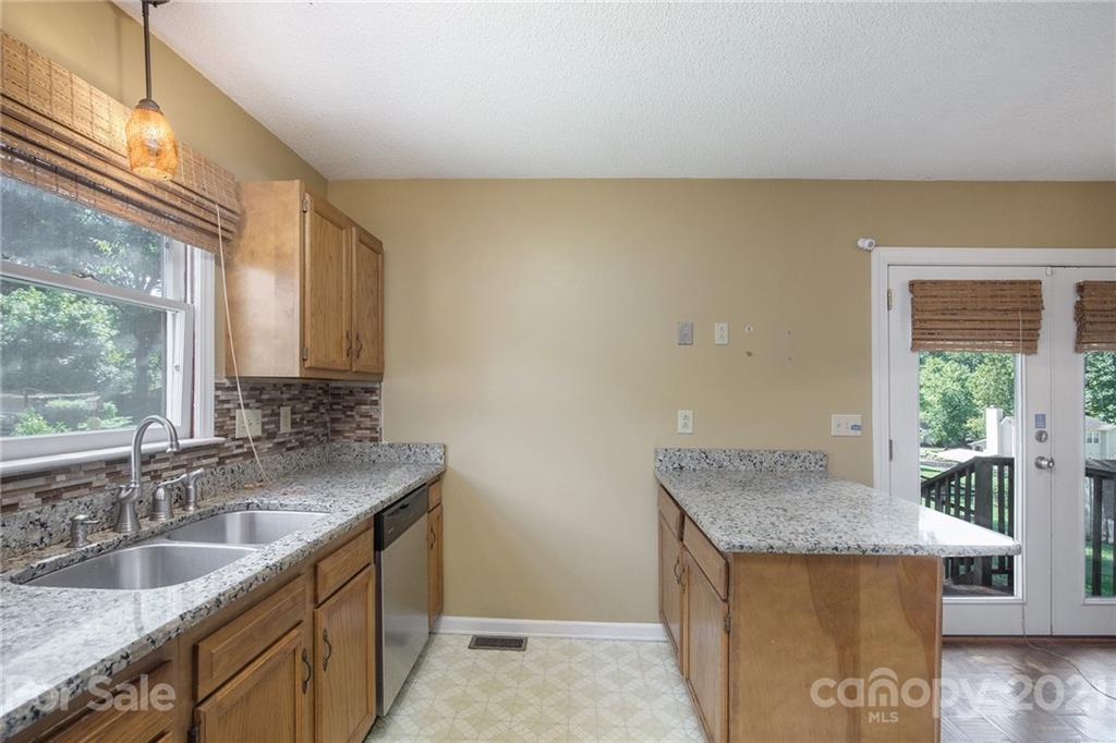 5625 Beaconsfield Road Charlotte, NC 28214 - Photo 5 of 21 a kitchen with granite countertop sink and cabinets