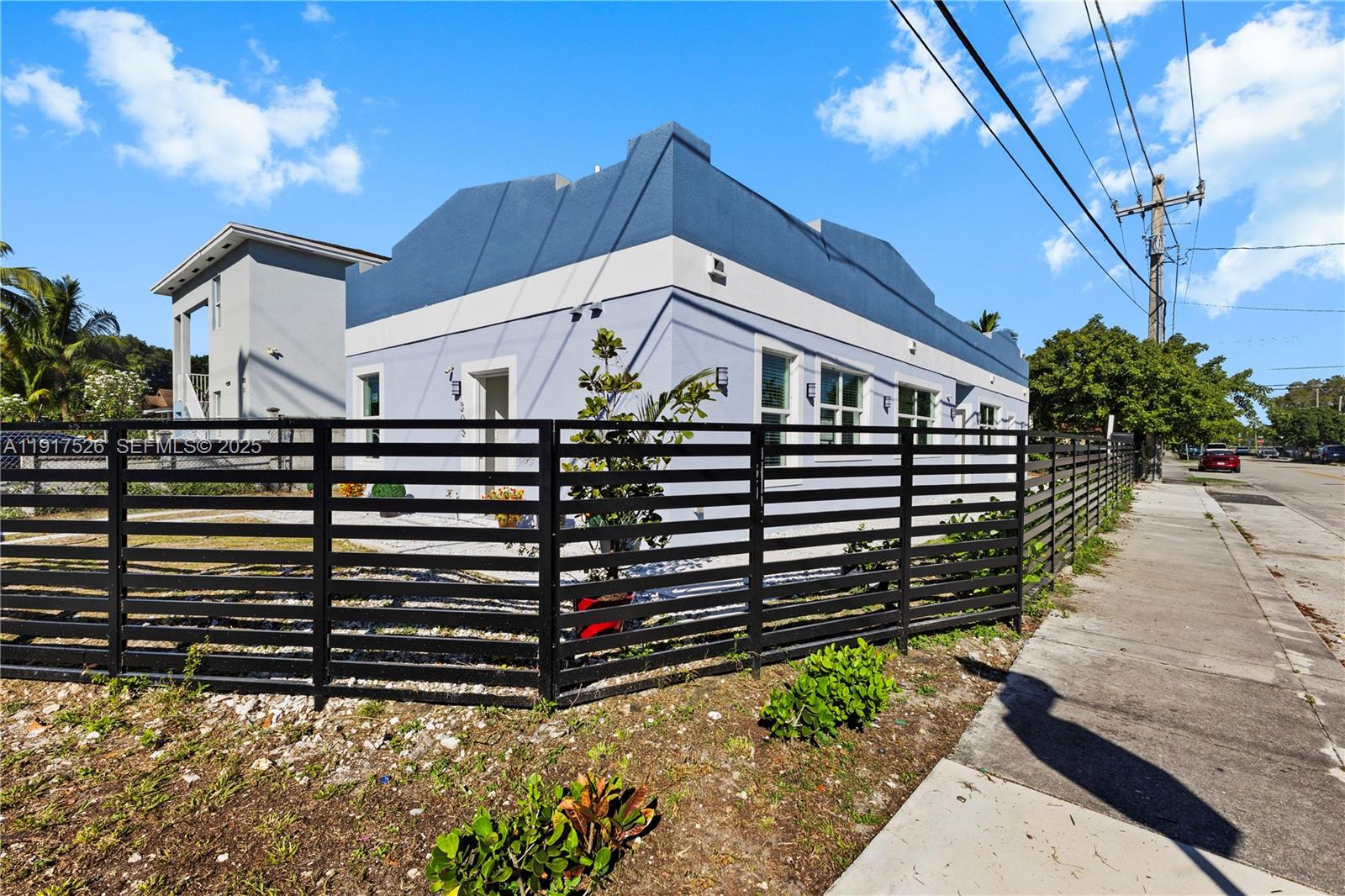 305 Northwest 58th Street Miami, FL 33127 - Photo 11 of 20 a front view of a house with a yard