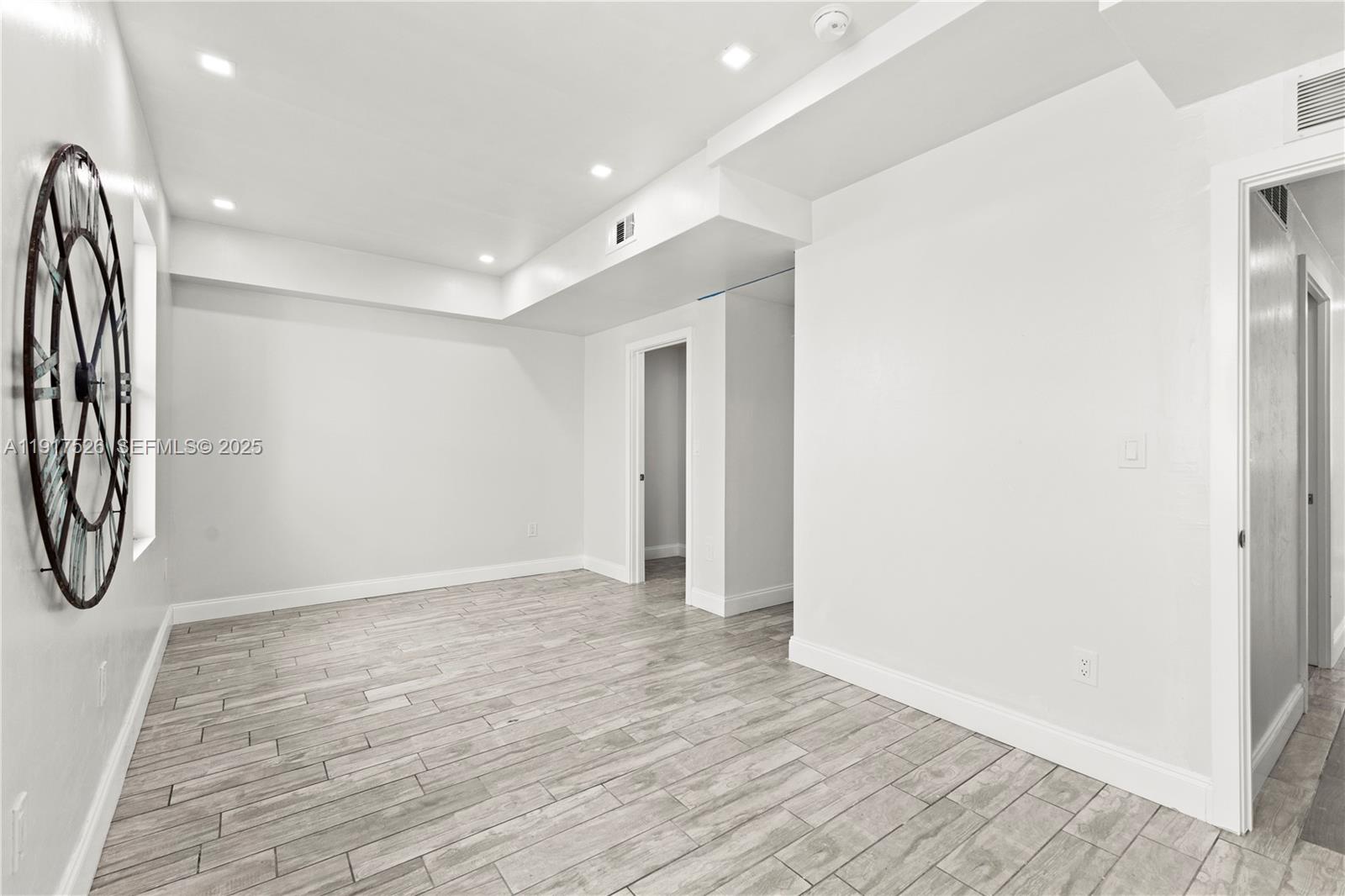 305 Northwest 58th Street Miami, FL 33127 - Photo 16 of 20 a view of a hallway with wooden floor