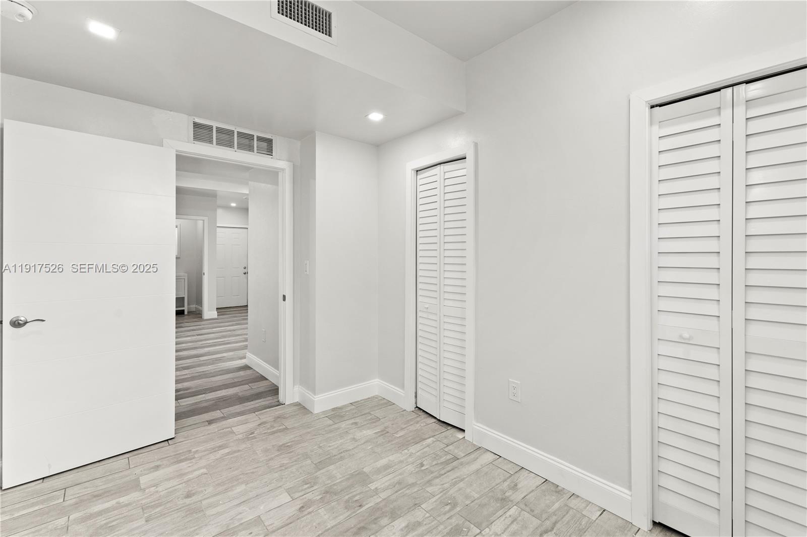 305 Northwest 58th Street Miami, FL 33127 - Photo 17 of 20 a view of a hallway with wooden floor and staircase