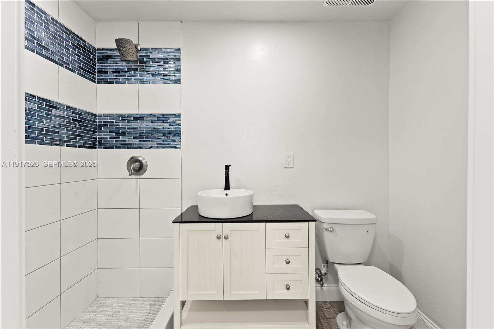 305 Northwest 58th Street Miami, FL 33127 - Photo 18 of 20 a bathroom with a granite countertop toilet and sink
