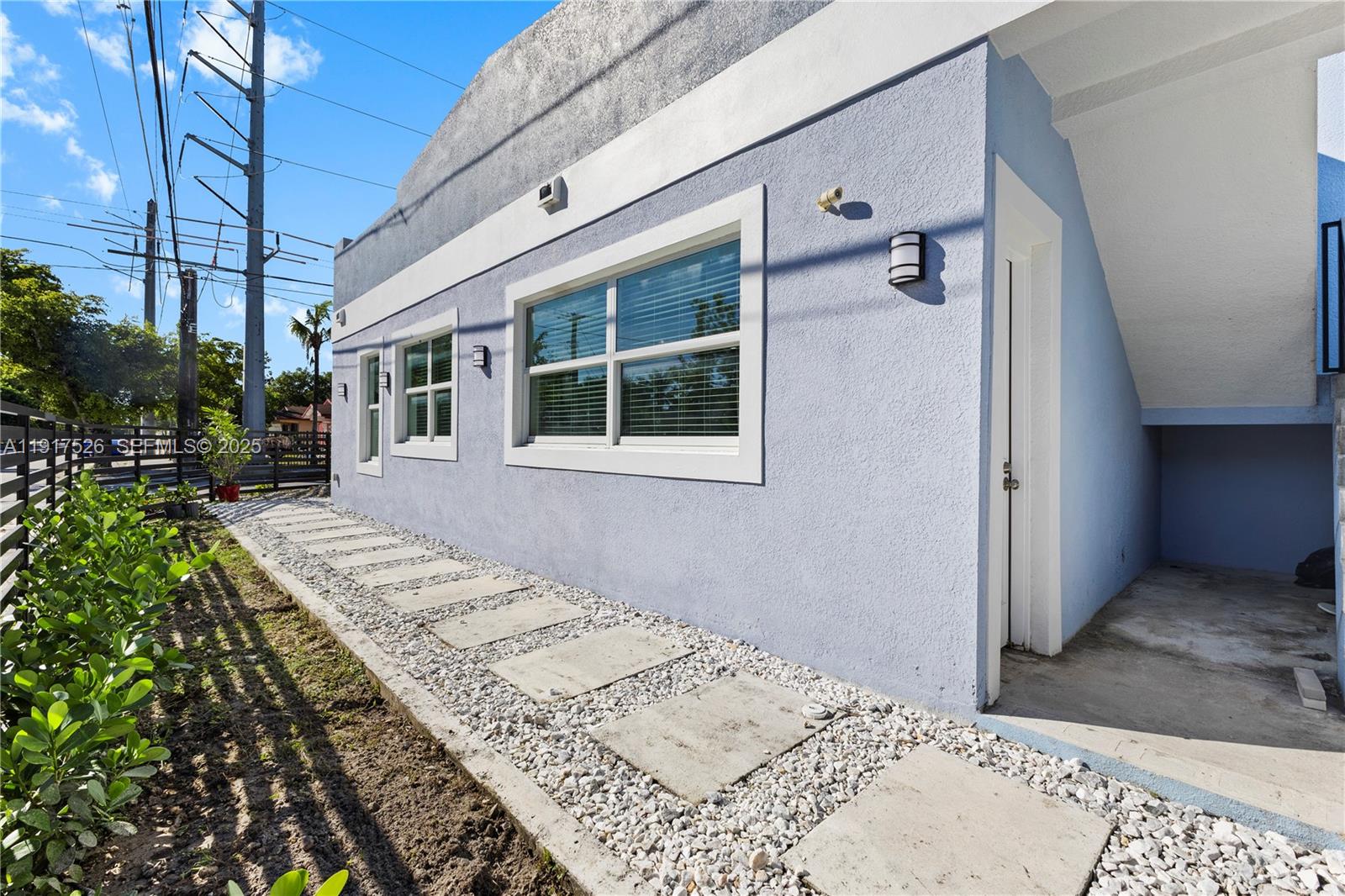 305 Northwest 58th Street Miami, FL 33127 - Photo 8 of 20 a view of balcony with wooden floor and plants