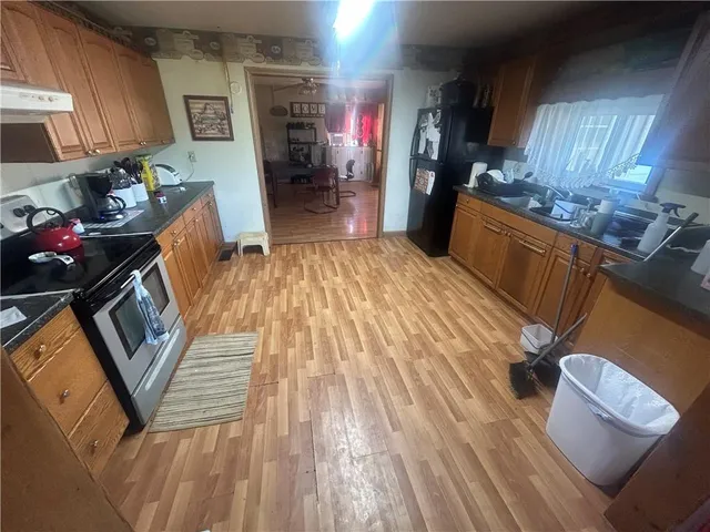 a kitchen with wooden floors and sink