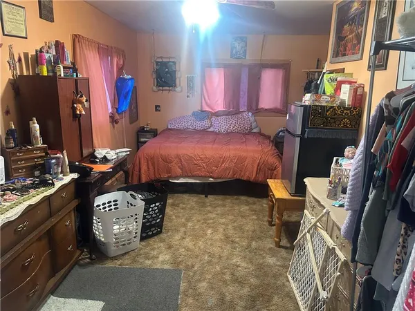 a bed room with a bed and a television