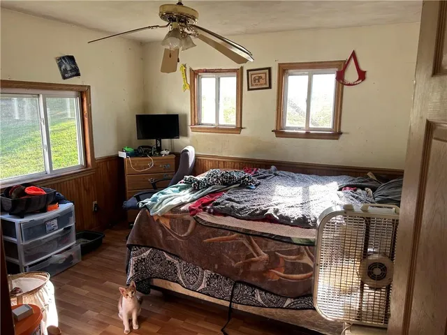 a bedroom with a bed and window