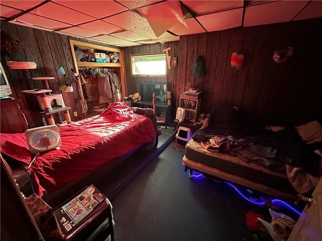 a bed room with bed and gym equipment