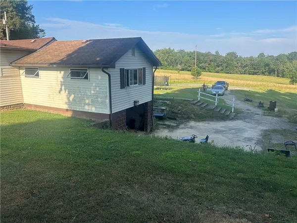a view of a house with a backyard