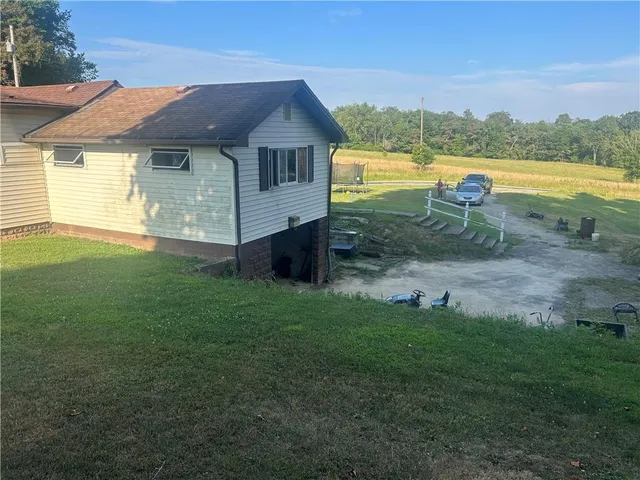 a view of a house with a backyard