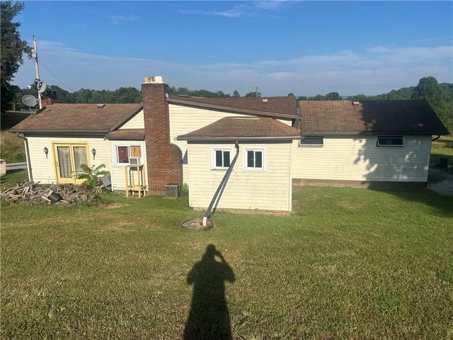a view of yard and swimming pool with green space