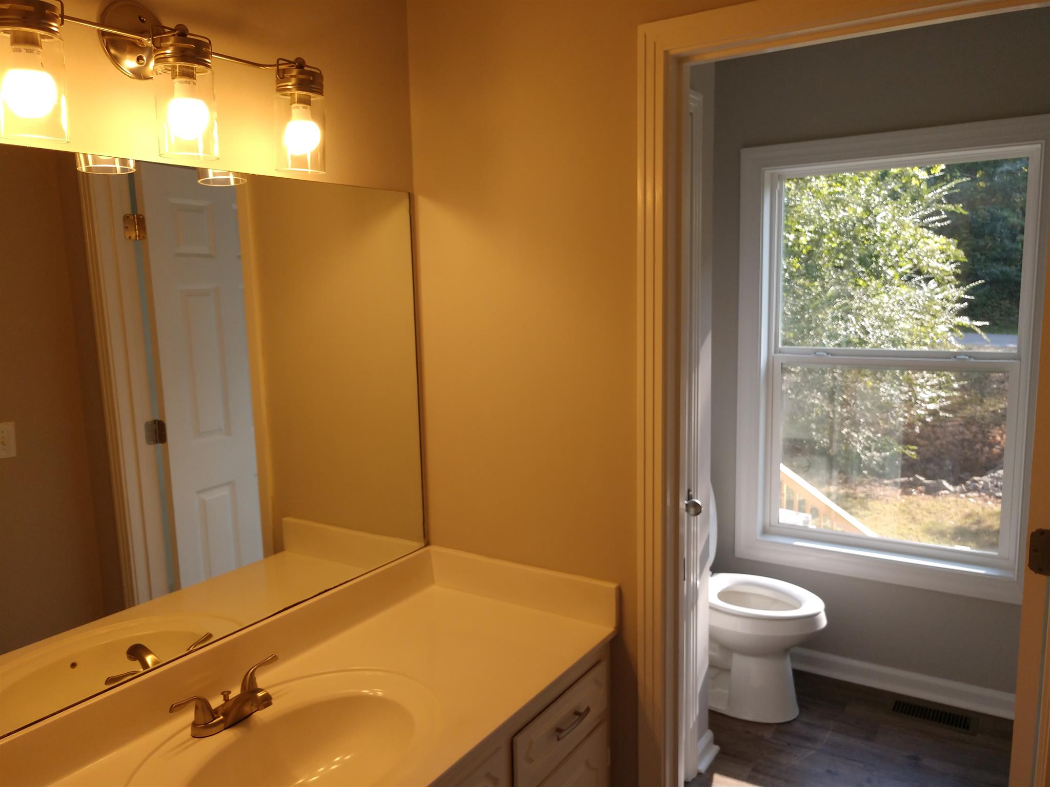 336 Harper Road Clarksville, TN 37043 - Photo 14 of 20 a bathroom with a granite countertop sink toilet and shower
