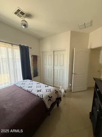 a living room with furniture a flat screen tv and a large window