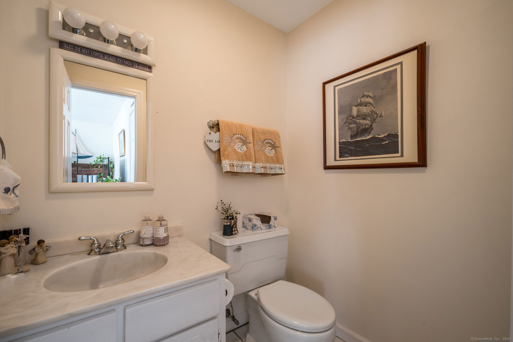 45 Wilshire Road, Unit 45 Madison, CT 06443 - Photo 11 of 25 a bathroom with a toilet a sink and mirror
