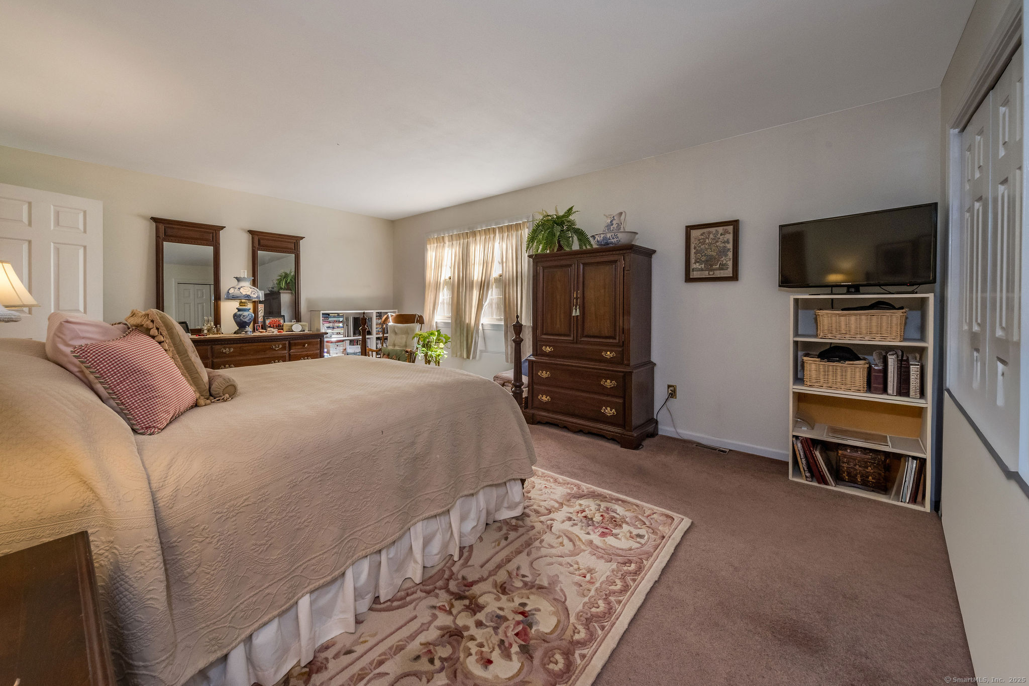 45 Wilshire Road, Unit 45 Madison, CT 06443 - Photo 13 of 25 a bed room with a bed and a television