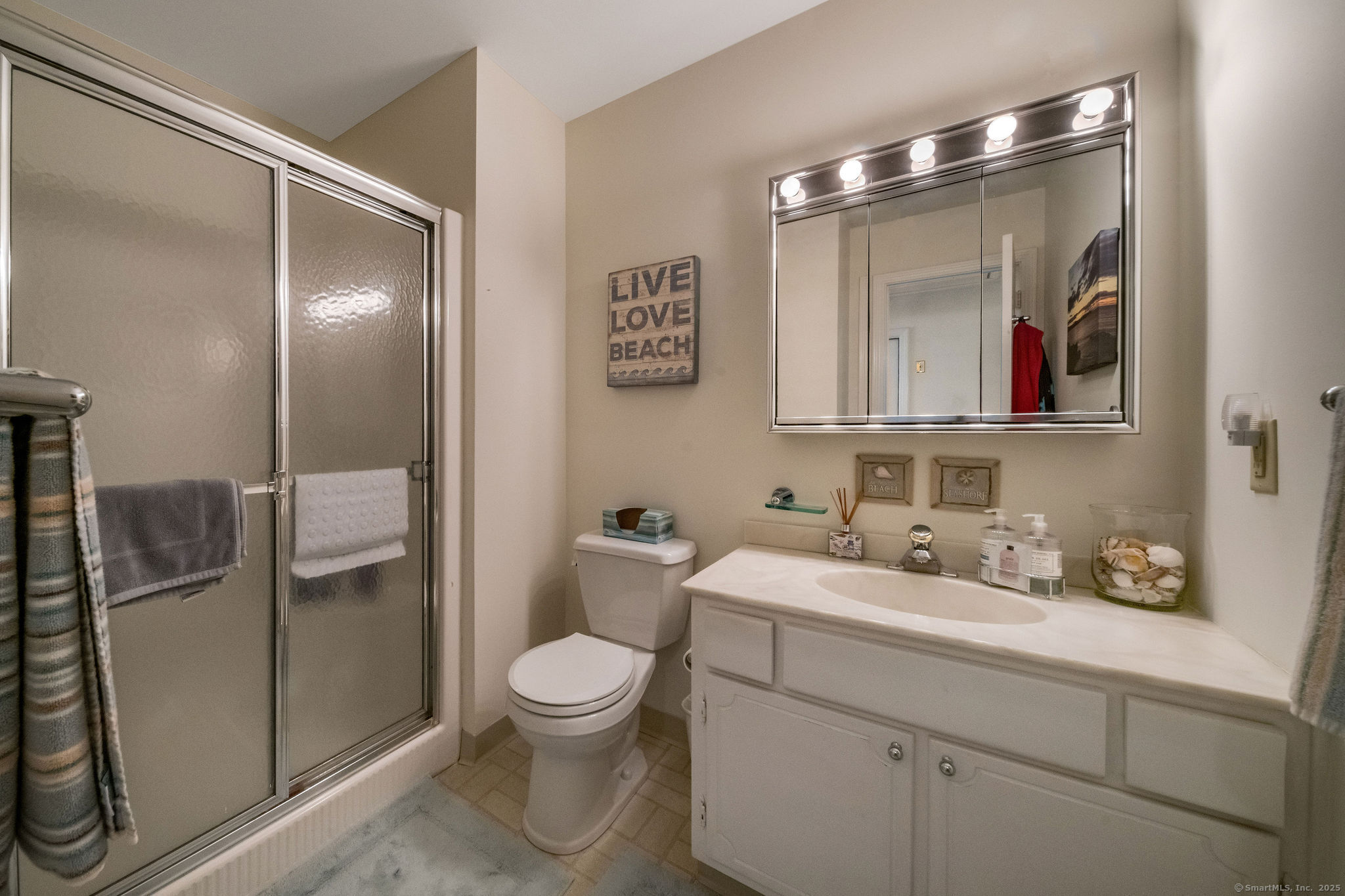 45 Wilshire Road, Unit 45 Madison, CT 06443 - Photo 16 of 25 a bathroom with a toilet sink and mirror