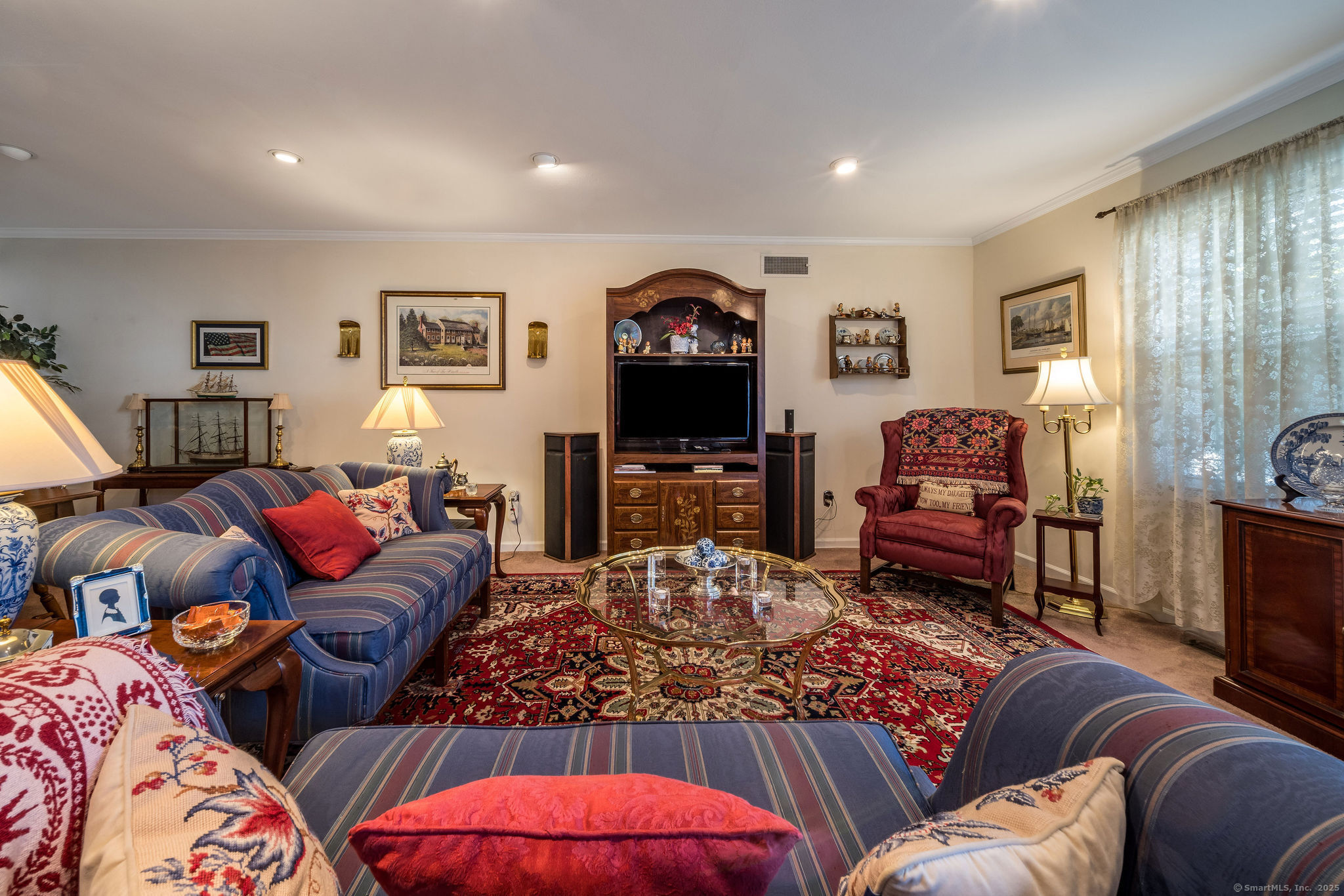 45 Wilshire Road, Unit 45 Madison, CT 06443 - Photo 3 of 25 a living room with furniture a flat screen tv and a fireplace