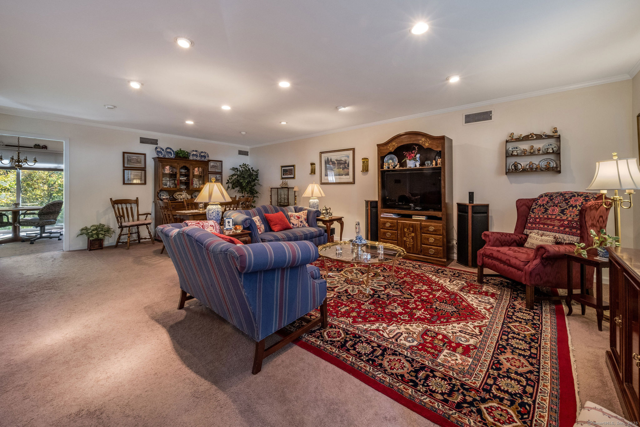 45 Wilshire Road, Unit 45 Madison, CT 06443 - Photo 4 of 25 a living room with furniture and a flat screen tv