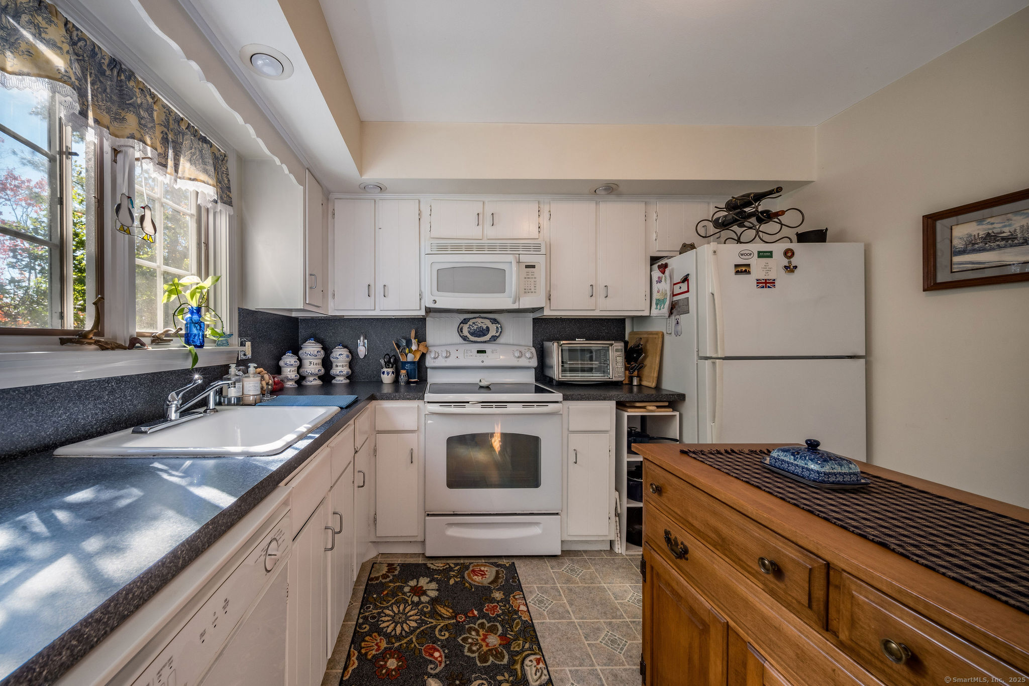 45 Wilshire Road, Unit 45 Madison, CT 06443 - Photo 7 of 25 a kitchen with granite countertop a sink stainless steel appliances and cabinets