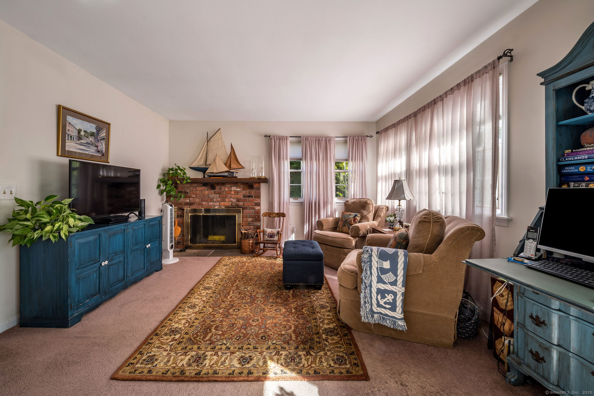 45 Wilshire Road, Unit 45 Madison, CT 06443 - Photo 10 of 25 a living room with furniture a flat screen tv and a fireplace