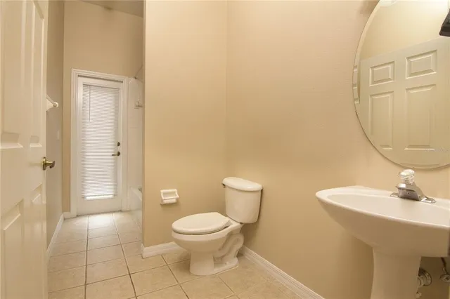 a white toilet sitting next to a bathroom sink