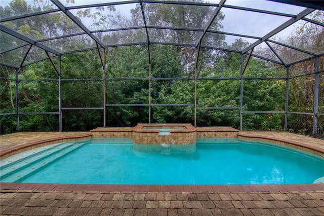 a view of a backyard with a small swimming pool