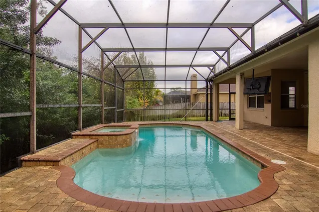 a view of a swimming pool with a patio