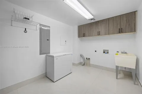 a view of storage and utility room with a sink