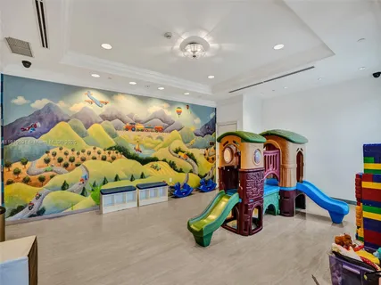 a bedroom with bed and a chandelier