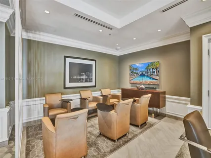 a living room with furniture and wall paintings