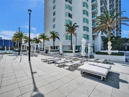 a view of a patio with swimming pool and chairs
