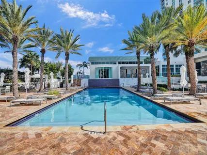 a tennis court with view of buildings in the background