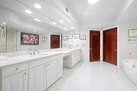 a spacious bathroom with a sink a mirror and a bathtub