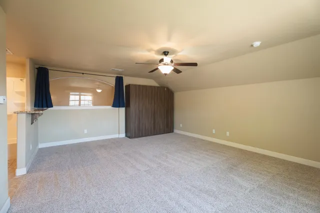 a view of a livingroom with a ceiling fan and window