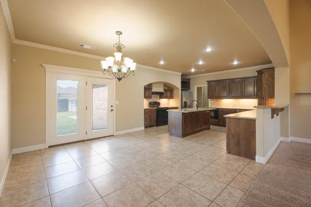 a large kitchen with a refrigerator and a stove top oven