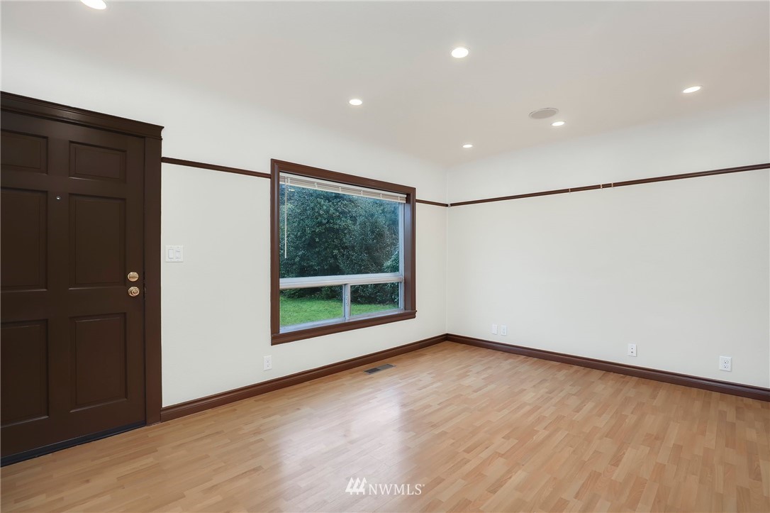 617 Reiten Road Kent, WA 98030 - Photo 2 of 30 a view of a big room with wooden floor and windows